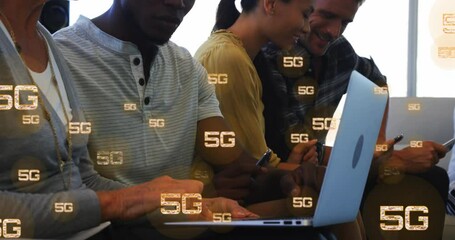 Poster - Animation of multiple 5g texts over diverse coworkers working and using laptop in office