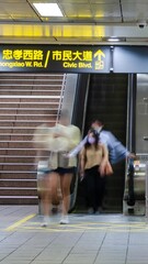 vertical timelapse of crowded passenger while using escalator going up and down to subway metro trai