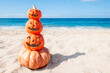 Happy Halloween beach background with four pumpkins