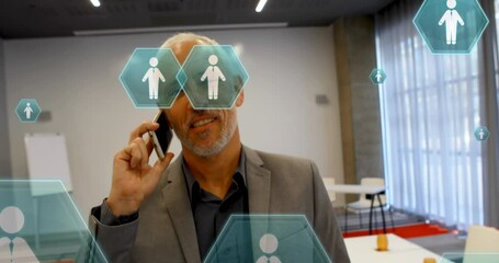 Poster - Animation of people icons over caucasian businessman using smartphone
