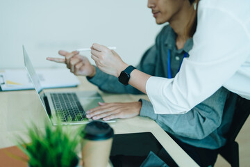 Wall Mural - Two business men meeting to talking or discuss marketing work in workplace using paperwork, calculator, computer to work.