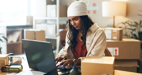 Canvas Print - Woman, laptop and typing in small business logistics for order, ecommerce or design at boutique. Female person, tailor or fashion designer on computer for inventory, storage or inspection at store