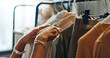 © N Felix/peopleimages.com - Hands of designer, clothes rail or choice in studio, workshop or small business for sample, show or collection. Creative woman, closeup or decision for design, fabric or clothing fashion in store