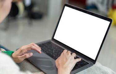 Wall Mural - Woman working with modern laptop computer blank white desktop screen for advertising, mockup, technology, advertising, search information, creative design on table