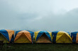 Tent in camping with flog and mountain view. Tent on campsite by the hill in rainy day. Tent wet after rain. Water droplets on the tent. Khao Kho, Phetchabun Province in Thailand.