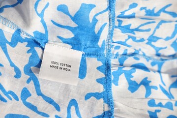 Wall Mural - Clothing label on color garment, closeup view