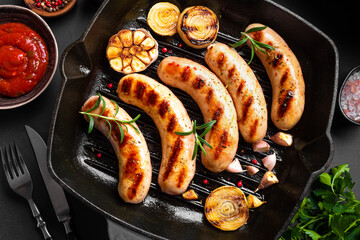 Canvas Print - Grilled sausages with sauce and herbs