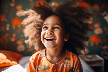 Wall Mural - Smiling young Afro girl in her living room with a floral wall background and a cheerful face.