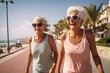 two old women are joyfully strolling along the beachside sidewalk in their summer workout attire. generative AI