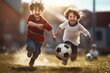 © inthasone - Cute little children playing football outdoors, happy and smile.
