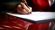Mujer con un vestido rojo elegante firmando un documento en un despacho