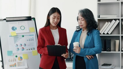 Wall Mural - Senior businesswoman has work meeting with employees in the finance department, senior female leaders in organization, company financial planning meeting. Concept of meeting together in the company.