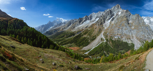 Wall Mural - The panorama of Val Ferret, one of the Italian valleys that directly overlook Mont Blanc, during an autumn morning, near the town of Entreves, Valle d'Aosta, Italy - 2 October 2023.