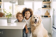 Cheerful little boys are posing with a golden retriever dog at the kitchen table. Funny kids and their pet preparing for breakfast at home. Happy smiling brothers and puppy enjoy their time together.