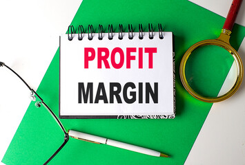 Poster - PROFIT MARGIN text on notebook on green paper