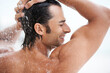 © Marine G/peopleimages.com - Shower, happy and man with water for cleaning, washing hair and grooming for healthy skin. Beauty, spa treatment and person smile with splash for hygiene, wellness and skincare hydration and cleanse