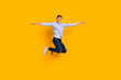 © Tetiana - Full length body size view of attractive shopping guy jumping up show new clothes isolated yellow color background