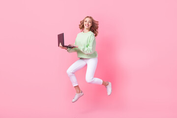 Poster - Full body profile photo of crazy cheerful lady jump rush use netbook empty space isolated on pink color background