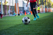 © chitsanupong - Children playing control soccer ball tactics on grass field with for training