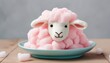 Pink cotton candy in the shape of cute sheep on the blue plate. Eastern holiday seasonal food sweet background. Spring celebration backdrop