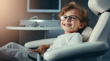 Happy Child In Glasses Sitting In Dentist's Chair