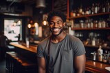 Fototapeta  - Portrait of a smiling young waiter in a bar