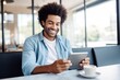 © Georgii - Portrait of cheerful African American businessman in casual clothes with smartphone and cup of coffee. Happy smiling mature man, successful entrepreneur or employee working in office or coworking cafe