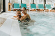 © BGStock72 - Young couple relaxing in the indoor swimming pool