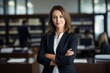 © amnaj - Professional female lawyer standing with arms crossed in the office.