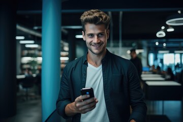 Wall Mural - Business man reading a message on a mobile phone in an office