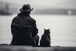 Back view of an elderly man in a hat and his pet black cat sitting on the shore of the lake