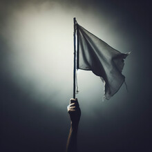 Close Up Arm Holding Stick With A Worn White Flag In Fog On Dark Background