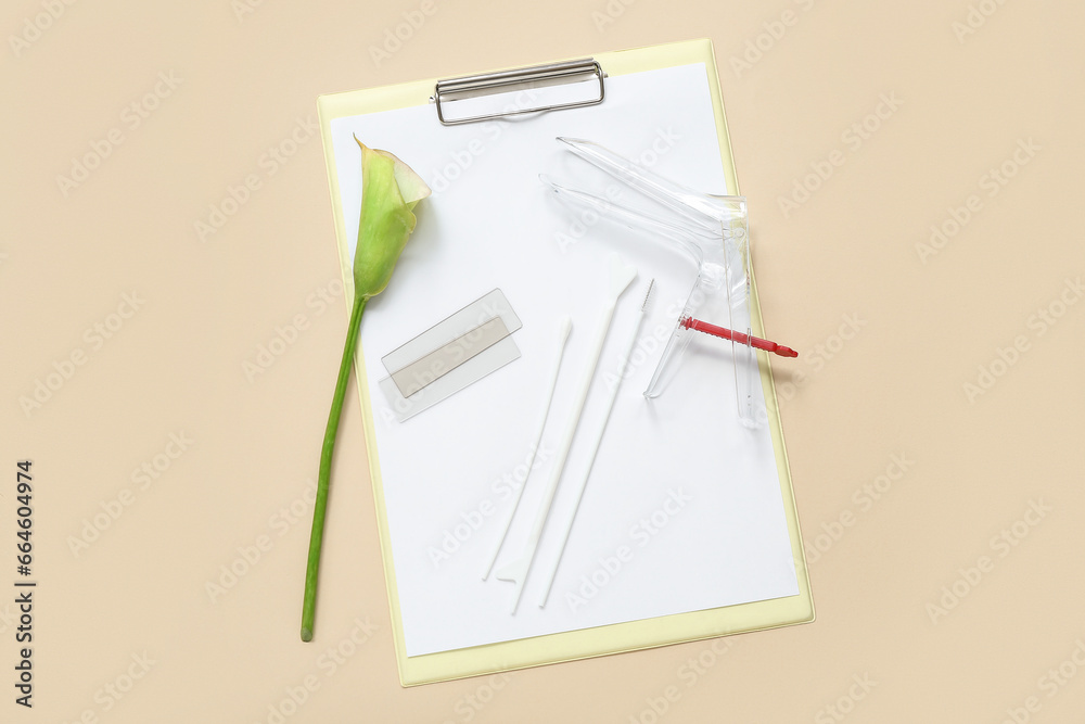 Gynecological speculum with pap smear test tools and clipboard on light background