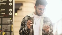 Portrait Of Young Man Hold Smartphone Scrolling Social Media Texting Browsing Online At Urban City Handsome Male Relax Enjoying Great Day With Cup Of Coffee Or Tea At Street Outdoors 4k Footage