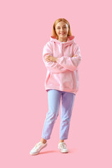 Wall Mural - Mature woman in hoodie on pink background