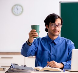 Sticker - Young male teacher in front of chalkboard