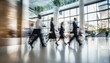 © ibreakstock - Long exposure shot of fast moving business people in bright office lobby with blurry trail