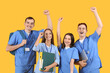 © Pixel-Shot - Group of medical students on yellow background