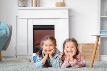 Poster - Cute little girls lying on floor at home