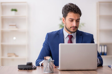 Young male employee working in the office