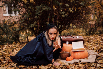 A young witch in the forest makes a spell. Magic in the forest. Halloween