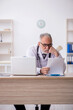 © Elnur - Old male doctor working in the clinic