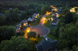 American dream homes at night on rural cul-de-sac street in US suburbs. View from above of brightly illuminated residential houses in living area in Rochester, NY