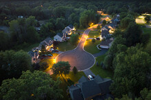 American Dream Homes At Night On Rural Cul-de-sac Street In US Suburbs. View From Above Of Brightly Illuminated Residential Houses In Living Area In Rochester, NY
