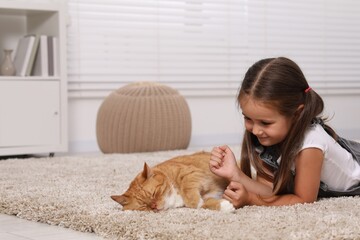 Sticker - Smiling little girl and cute ginger cat on carpet at home, space for text