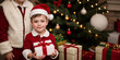 © PNG&Background Image - A kid wearing a Santa costume holding a gift box, Christmas background with copy space