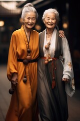 Two white haired grandmothers with wrinkles on their faces dressed in ancient Chinese.