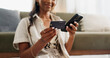 © N Felix/peopleimages.com - Happy woman, hands and phone with credit card for payment, online shopping or transaction in living room at home. Closeup of female person or shopper on mobile smartphone with debit for ecommerce