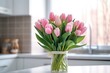 A bouquet of tulips on a white table.