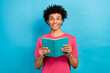 © deagreez - Photo portrait of nice young guy hold book excited reading dressed stylish pink garment isolated on blue color background